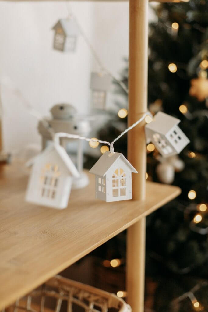 a wooden shelf with a christmas tree in the background