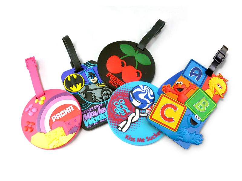 Four luggage tags with different characters on them.